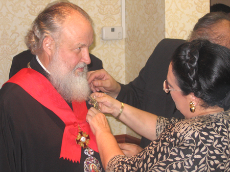 The Grand Duchess bestows the devices of the Order of St. Alexander Nevskii (First Class) upon Metropolitan Kirill